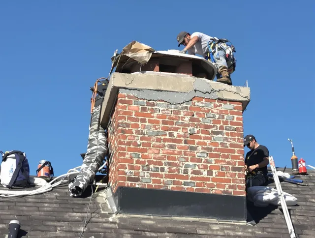 Rockland Chimney Sweep installing a custom chimney crown in Rockland, MA