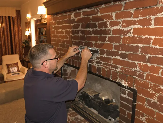 Rockland Chimney Sweep expert fixing a fireplace in Rockland, MA